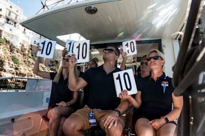 Judges score a dive during the first competition day of the sixth stop of the Red Bull Cliff Diving World Series at Polignano a Mare, Puglia, Italy on September 25, 2021. 