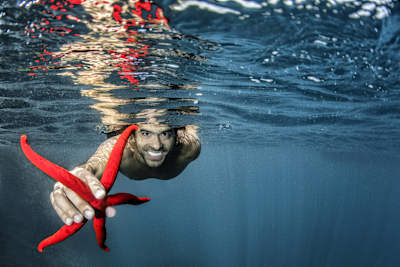 An image of cliff diver Orlando Duque underwater in Portugal. 