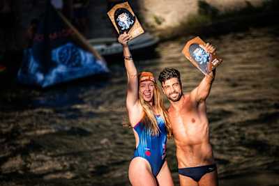 Molly Carlson and Carlos Gimeno hold their winners' trophies up at Red Bull Cliff Diving, Mostar, Bosnia and Herzegovina, September 2023.