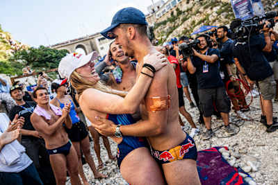 In 2023, Molly Carlson and Aidan Heslop celebrate at Polignano a Mare, Italy, during the Red Bull Cliff Diving World Series event.