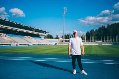 In 2024, Jonne Koski stands on the athletics track in Lahti, Finland, smiling confidently