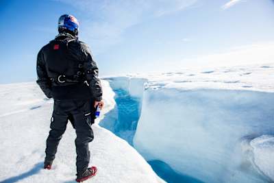 Aniol Serrasolses scouts the river on Austfona ice cap in Svalbard 