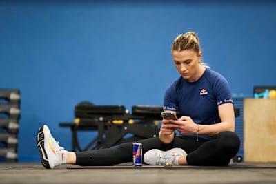 One of the most revered sabre fencers in the world, Olga Kharlan, checks her phone during training