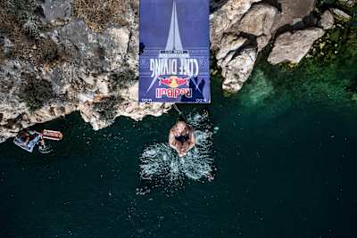 Meili Carpenter of the USA dives during the first stop of the Red Bull Cliff Diving World Series at Lake Vouliagmeni in Athens, Greece on May 25, 2024.