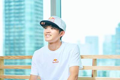 Sorato Anraku poses for a portrait in Red Bull-branded hat and t-shirt.