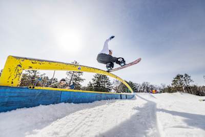Zeb Powell hits a rail at the Red Bull Slide In Tour at Trollhaugen Ski Area in Dresser, Wisconsin, USA, on March 2, 2024. 