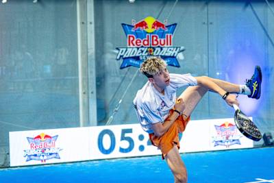 A dynamic Spanish player delivers an intense shot during the Red Bull Padel Dash World Final 2025 in Sevilla, capturing the high-energy spirit of the event