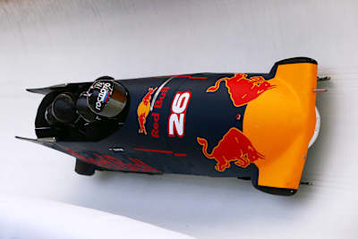 Members of the Russian national bobsleigh team ride in a Red Bull Racing bobsleigh during previews to the Formula One Grand Prix of Russia at Sanki Sliding Centre on April 27, 2016 in Sochi, Russia.