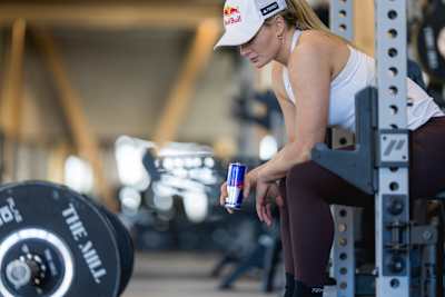 New Zealand's pro alpine skier Alice Robinson training in the weight room.