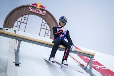 Japanese ski jumper Ryōyū Kobayashi seen focused at the top of the ski jumping hill.