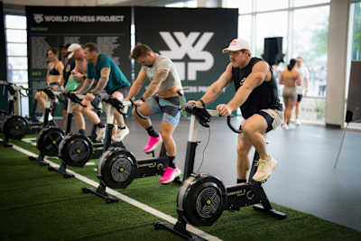 Functional fitness pro Noah Ohlsen intensifies his warm-up on the bike at World Fitness Project Tour.