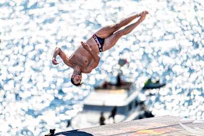 Aidan Heslop of the UK executes a perfect dive in Antalya, Turkiye during the Red Bull Cliff Diving World Series 2024