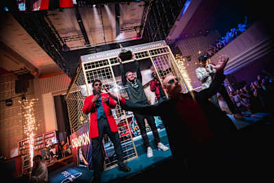 Adel 'Big Bird' Anouche lifts his trophy to the crowd during the Grand Final of Red Bull Kumite 2025 at the Maison de la Mutualité in Paris, France
