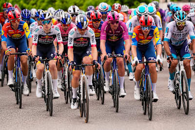 Primoz Roglic in the pink jersey and Mads Pedersen in the cyclamen jersey rode in the front group protected by their respective team mates. 