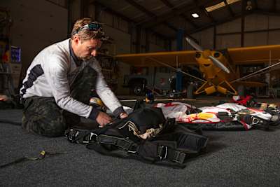 Jon DeVore packs his parachute packs at the Red Bull Air Force Training Camp in Los Alamos, California, USA on 7 April, 2021.
