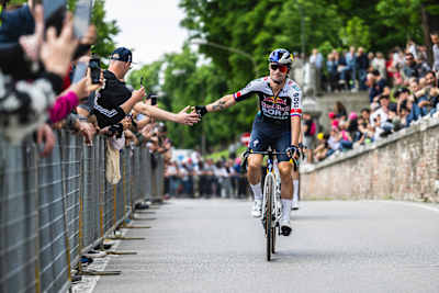 Primož Roglič accepts congratulations from the crowd lining the finish straight.