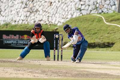 Dynamic cricket moment during the 2023 Red Bull Campus Cricket Women’s Final at Abhimanyu Cricket Academy Stadium, Dehradun, showcasing intense sporting spirit