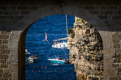 Molly Carlson plunges towards the Adriatic after leaping off the 21m platform in Polignano a Mare, Italy.