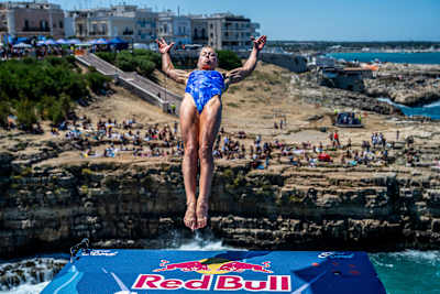 Lisa Faulkner of the USA soars from the 21 metre platform at the Red Bull Cliff Diving World Series 2025 in Polignano a Mare, Italy, capturing the thrill and adrenaline of the iconic event