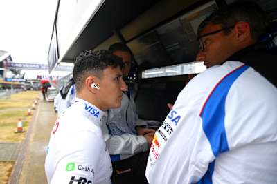 Isack Hadjar joins the Visa Cash App Racing Bulls team at the pit wall, Silverstone Circuit, during the 2025 Formula 1 Grand Prix of Great Britain in Northampton.