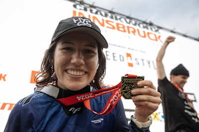 Jordy Scott proudly displays her gold medal after dominating the 2024 Red Bull Crankworx Speed and Style Pro Women’s Final in Innsbruck, Austria, capturing an epic victory