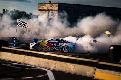 Red Bull Drift Pursuit ignites Spike Island, Cork in 2025 as Conor Shanahan performs a dramatic drift amid smoking tyres and cheering fans, capturing the energy of the event