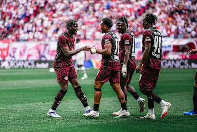RB Leipzig players celebrate on the pitch during their friendly match against Atalanta Bergamo in Leipzig.