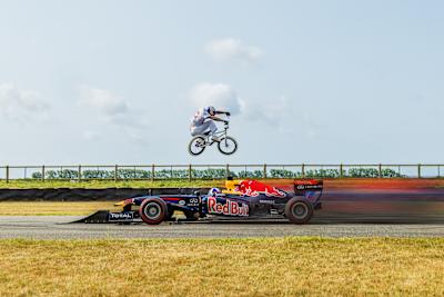 BMX rider Kriss Kyle leaps over Red Bull F1 car 