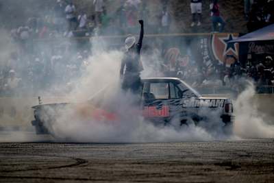 In Johannesburg 2024, Samkeliso Thubane drifts a Red Bull car through clouds of smoke at Mfest, electrifying the crowd at Kyalami with his bold, adrenaline-charged performance