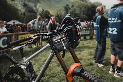 Asa Vermette's bike stands ready after his first-place qualification at Red Bull Hardline 2025 in Dinas Mawddwy, Wales, capturing the thrill of world-class downhill mountain biking.