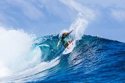 In 2025, Red Bull athlete Caroline Marks dominates the waves at Cloudbreak, Fiji during Title Match 1 of the Lexus WSL Finals, unleashing incredible surfing prowess on her branded board