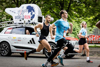 Beim Red Bull Wings for Life World Run 2025 gehen die Athleten in den Straßen Wiens an ihre Grenzen, verfolgt vom kultigen Catcher Car