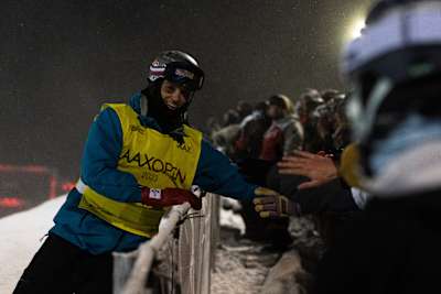 Scotty James, wearing his Red Bull helmet, connects with passionate fans at the Laax Open 2023 in Laax, Switzerland, bringing energy and excitement to the snowboarding event
