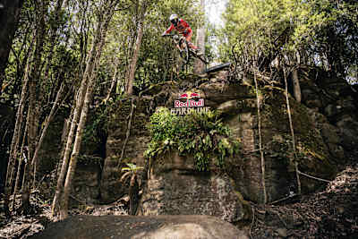 Jackson Goldstone soars over a rocky forest jump during practice at Red Bull Hardline 2026 in Maydena Bike Park, Australia
