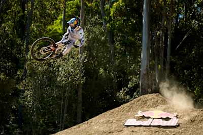 In 2026, Asa Vermette is airborne during a thrilling practice jump at Red Bull Hardline, Maydena Bike Park, Australia, where riders push the boundaries of gravity and skill