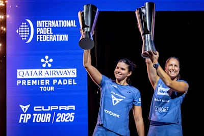 Gemma Triay and Delfina Brea celebrate as champions at the Premier Padel 2025 Finals in Barcelona, Spain, raising their trophies during the Champions Trophy Presentation