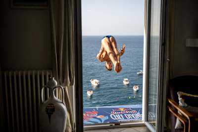 James Lichtenstein of the USA dives from a 26 metre balcony at Red Bull Cliff Diving World Series 2025 in Polignano a Mare, Italy, capturing daring athleticism over the Adriatic Sea