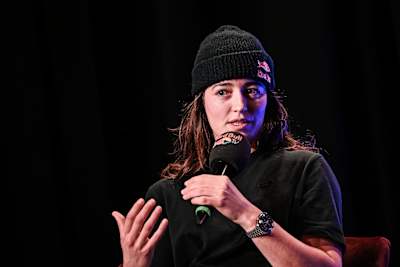 Freeskier Mathilde Gremaud addresses the audience at the 2025 premiere of She Who Flies at Plaza Klub in Zurich, Switzerland.