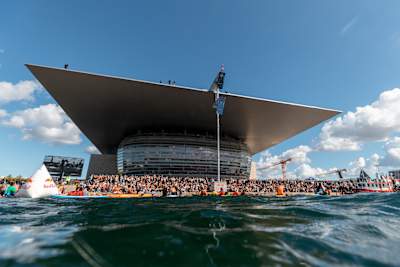 Copenhagen Opera House, with the cliff diving audience in front, is seen from the waterfront