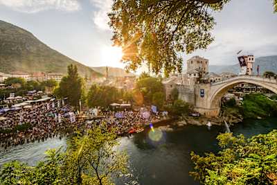 The sun shines on stunning Stari Most,Bosnia & Herzegovina, as crowds watch the cliff diving action