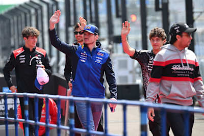 Max Verstappen and Andrea Kimi Antonelli wave on the drivers' parade prior to the F1 Grand Prix of Japan at Suzuka Circuit in March 2026 in Suzuka, Japan. 
