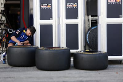A team member of Oracle Red Bull Racing checks the tyres in the Paddock during previews ahead of the F1 Grand Prix of Japan at Suzuka Circuit on March 26, 2026 in Suzuka, Japan.
