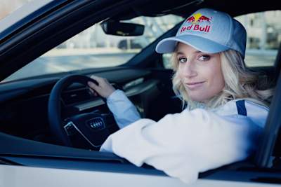 Anna Gasser is pictured in the Wings for Life World Run catcher car at Hangar-7, Salzburg, representing Red Bull on February 16, 2024, with signature dynamic energy