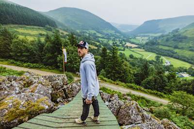 Legendary mountain biker Gee Atherton stands at the Red Bull Hardline in Dyfi Valley, Dinas Mawddwy, Wales, pictured on July 23, 2025, overlooking the epic course and stunning landscape.