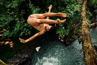 Miguel Garcia of Colombia dives from a tree at Kroya Waterfall during a free training session for the first stop of the Red Bull Cliff Diving World Series in Bali, Indonesia on May 19, 2026.