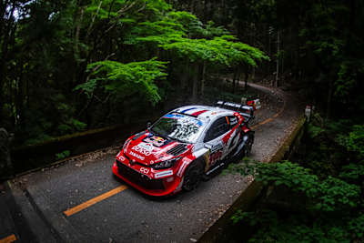 Sébastien Ogier and Vincent Landais power their car through the lush roads around Toyota City during Rally Japan 2026.