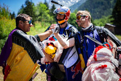 Wingsuit pilots Fred Fugen, Dani Roman and Marco Fuertz celebrate their world-first wingsuit formation flight above Mont Blanc