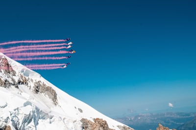 Wingsuit pilots Fred Fugen, Dani Roman, Marco Fuertz, Marco Waltenspiel and team blaze pink trails over Mont Blanc 