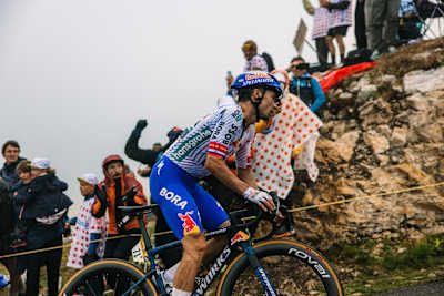 On July 24, 2025, Red Bull - BORA - hansgrohe rider Primož Roglič conquers Stage 18 at Courchevel COL DE LA LOZE during the Tour de France, cheered by fans on the mountain ascent