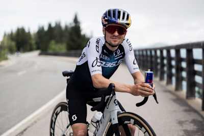 Tom Pidcock poses with a Red Bull can during Sound of Tarmac in Berchtesgaden, Germany, June 2025, celebrating Red Bull's cycling passion
